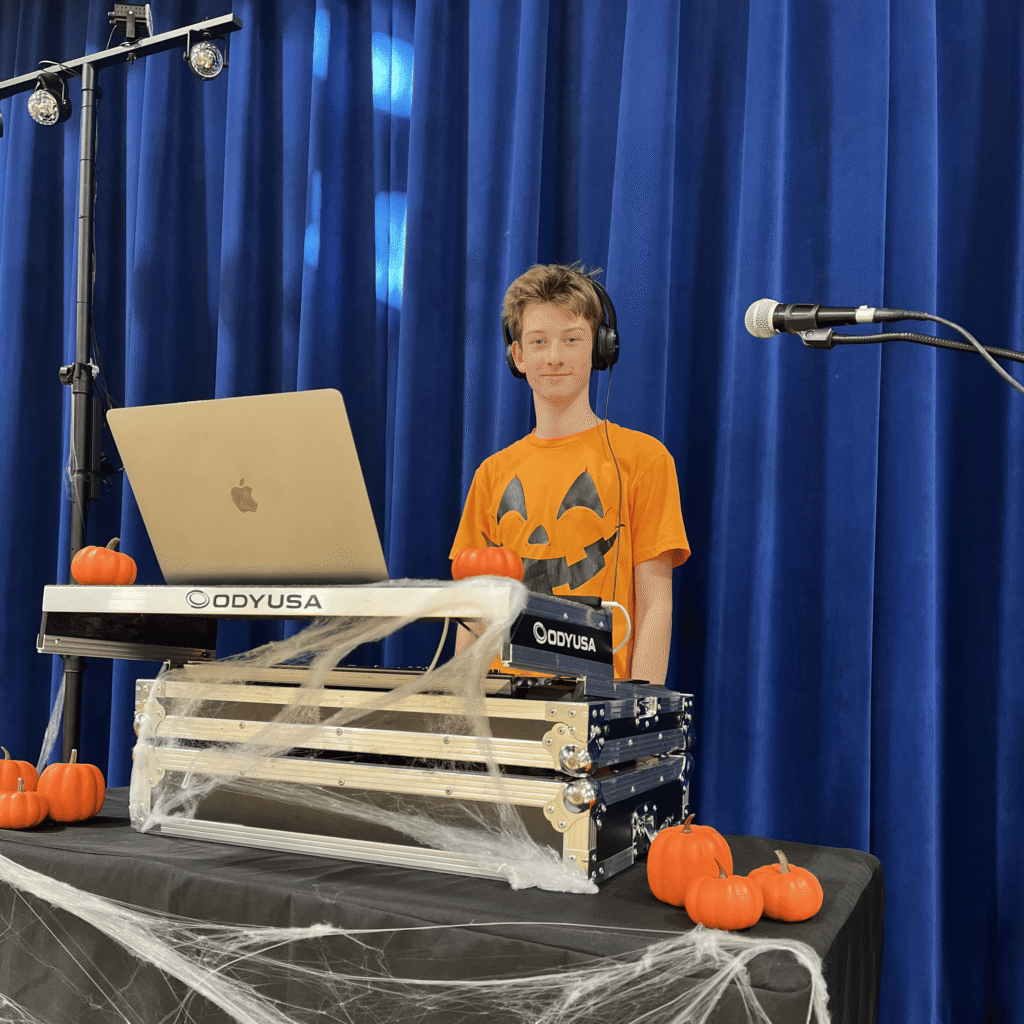 Photo of DJ Mason Mueller behind DJ booth.